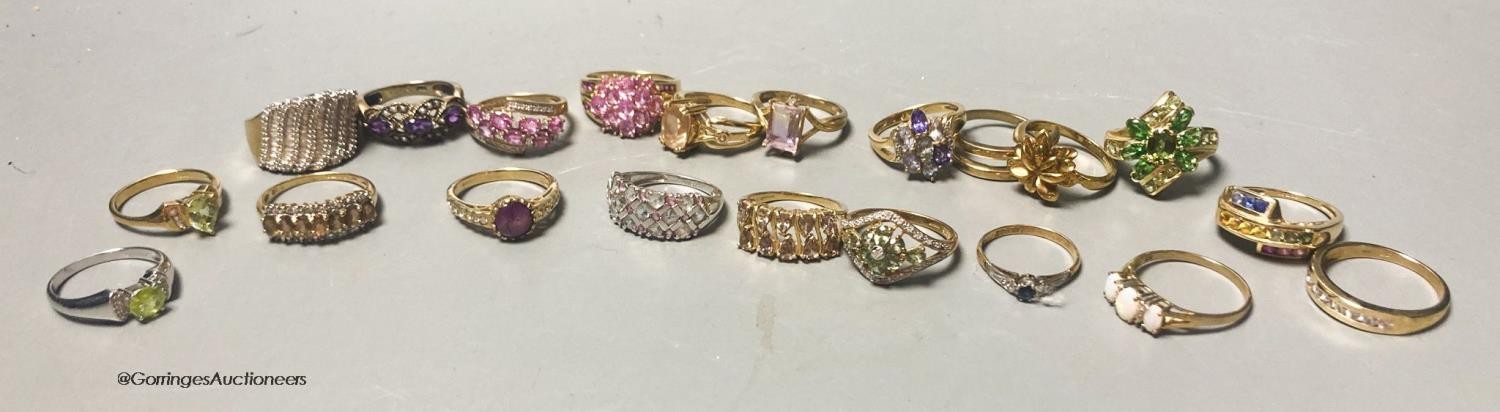 Twenty assorted modern 9ct or 9k and gem set dress rings, gross 66.4 grams.